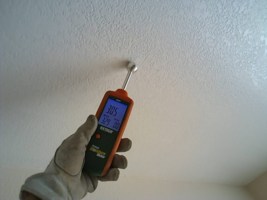Moisture meter confirmed elevated moisture levels associated with a ceiling leak during an Irvine home inspection