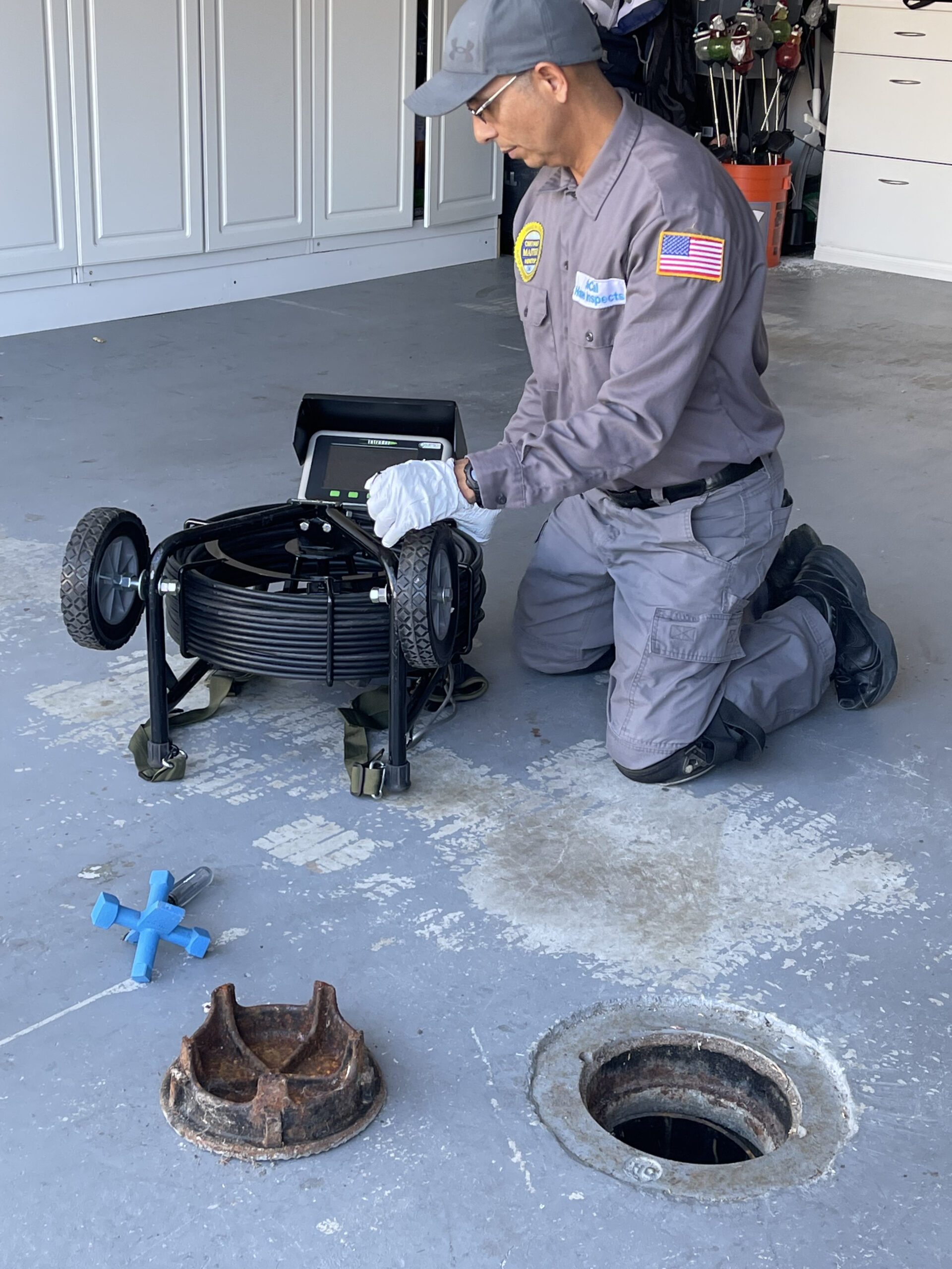 Certified Master Inspector performing a sewer inspection using a sewer camera before a home purchase