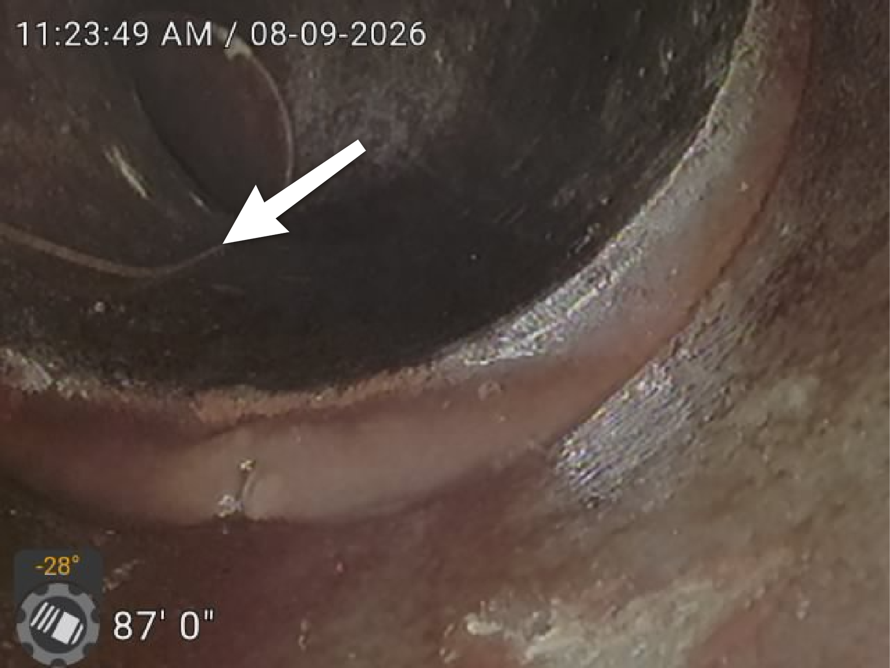 Sewer scope camera showing a cracked sewer line approximately 87 feet into the sewer lateral